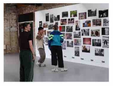 Artists visiting a wall of images