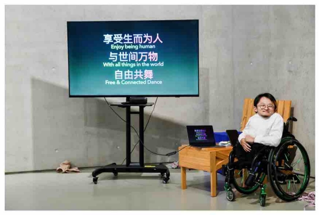 Gene speaking beside a projected image