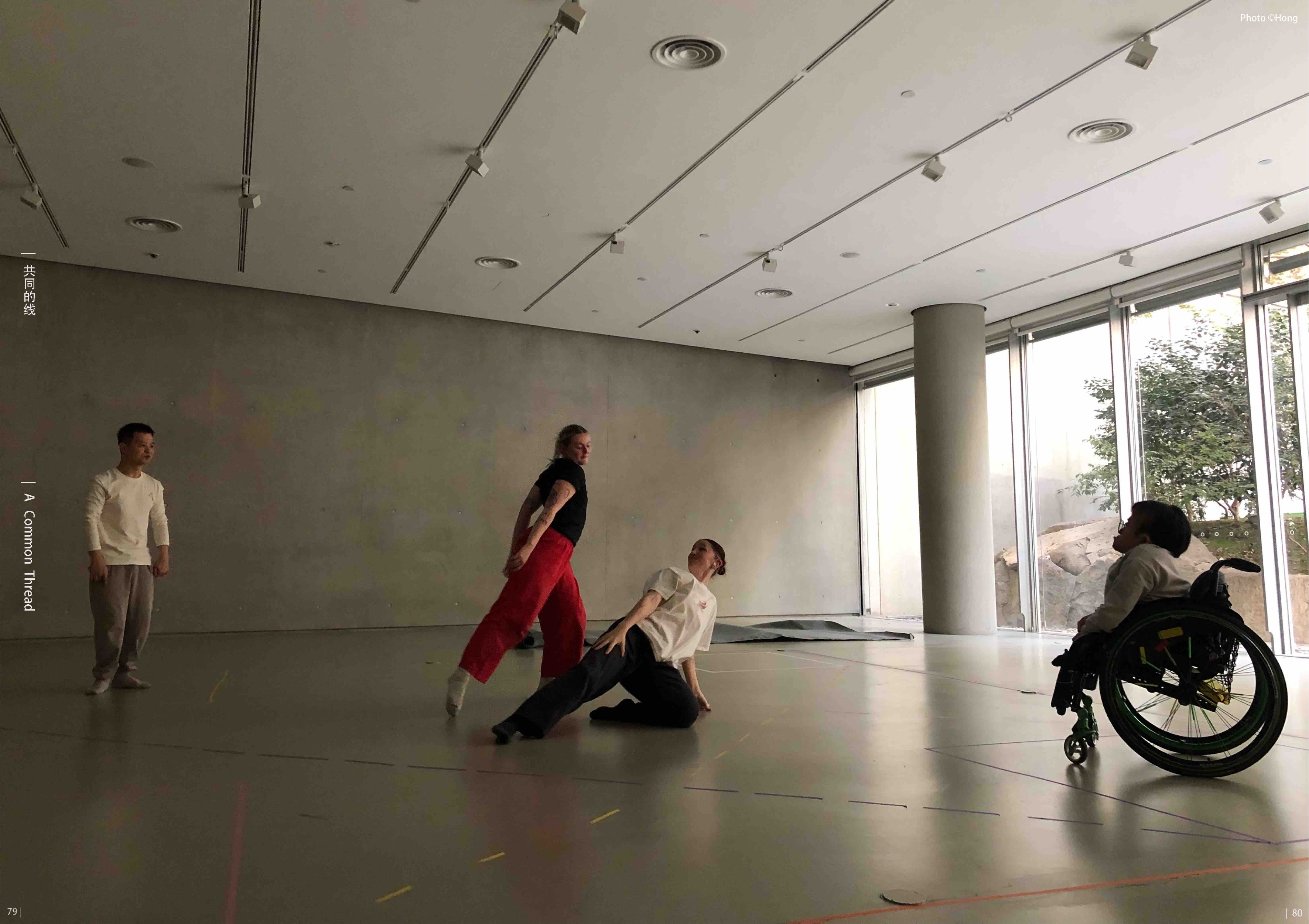A studio performance with a wheelchair user and two dancers